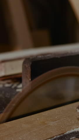 Workshop Scene With Rotary Saw In Motion, Carpenter Preparing Timber As Blade Swiftly Cuts Through . Media