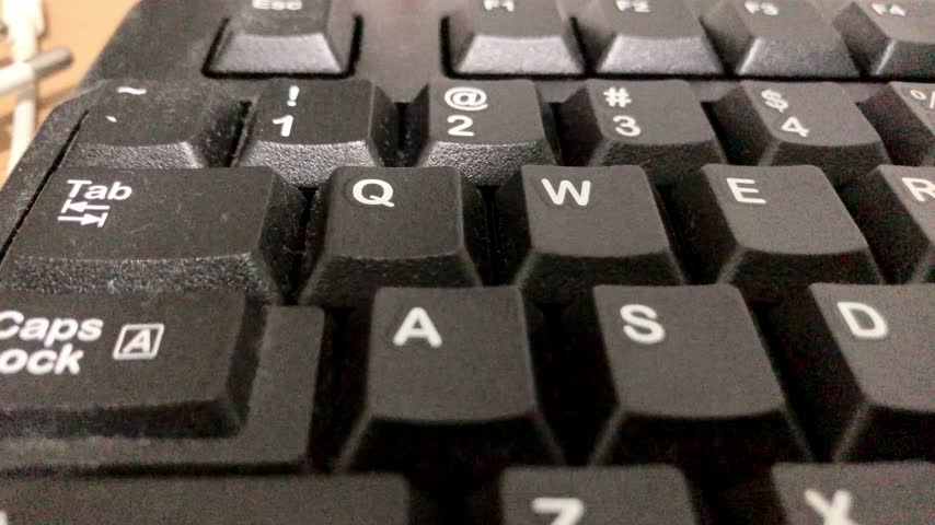 Close up perspective of PC keyboard keys, abstract technology background symbolizing digital work, programming, and internet activity.