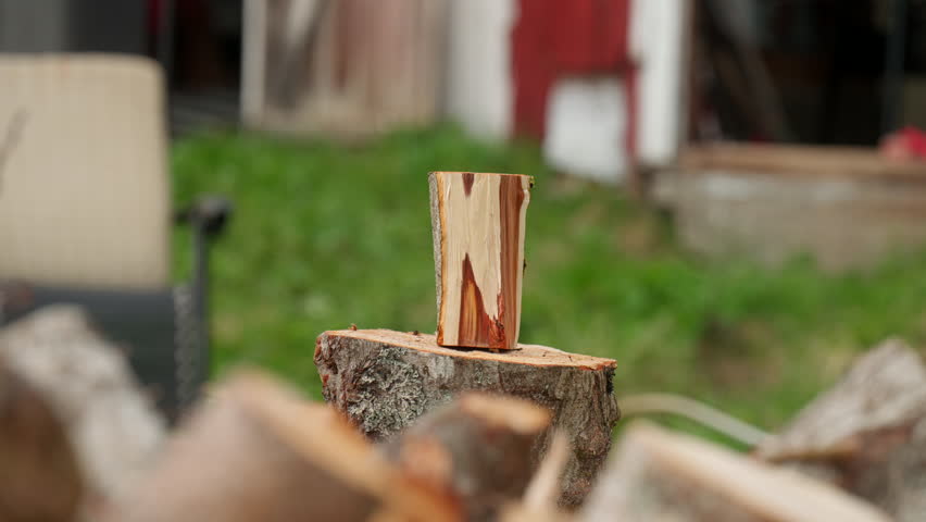 Person Splitting Wood With An Axe. - closeup shot