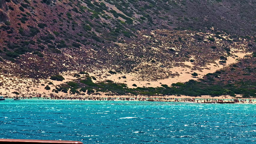 Distant View Of Crowded Shoreline Of Balos Beach In Crete, Greece. wide shot