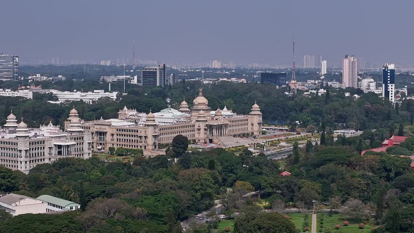 Aerial view of the majestic Vidhana Soudha in Bengaluru, Karnataka’s legislative building designed under Kengal Hanumanthaiah, standing prominently among dense greenery and urban landscape