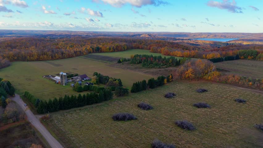 Leelanau County farm by Lake Michigan showing autumn colors and fields, USA in aerial view