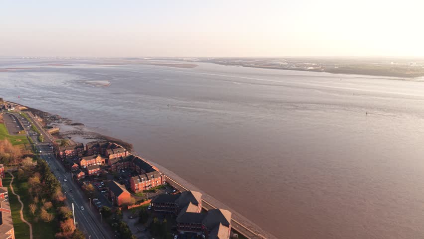 Drone image of the River Mersey showing dock areas, estuary water, and commercial port structures.