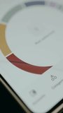 Person interacts with a donut chart on smartphone screen - Powered by Shutterstock - Get 15% off with code: PIKWIZARD15