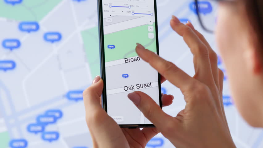 Real Estate Agent Carefully Searches Property Listings Online Using Computer And Phone.