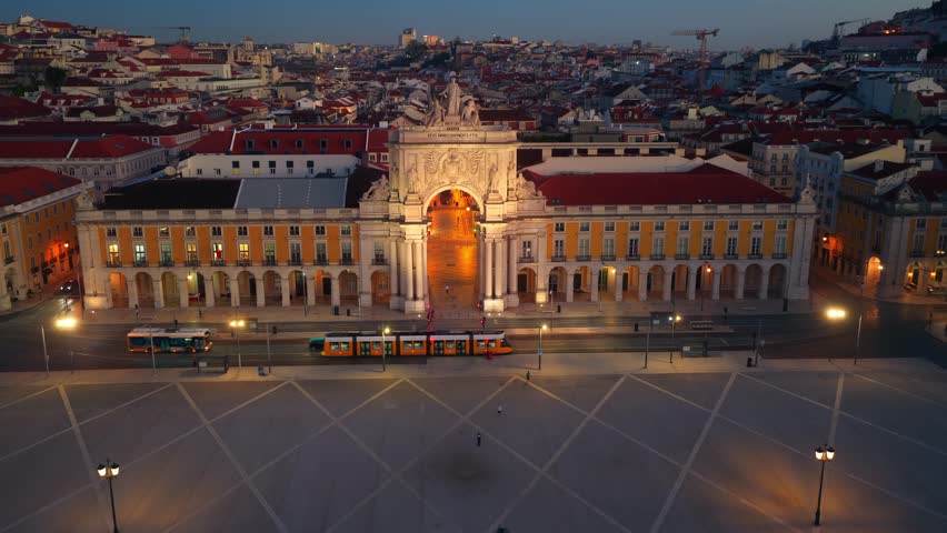 aerial shot of Lisbon historic centre in the evening with night lights, Commerce square and Augusta arch in Lisbon at night, the word Lisboa is written on the square. High quality 4k footage