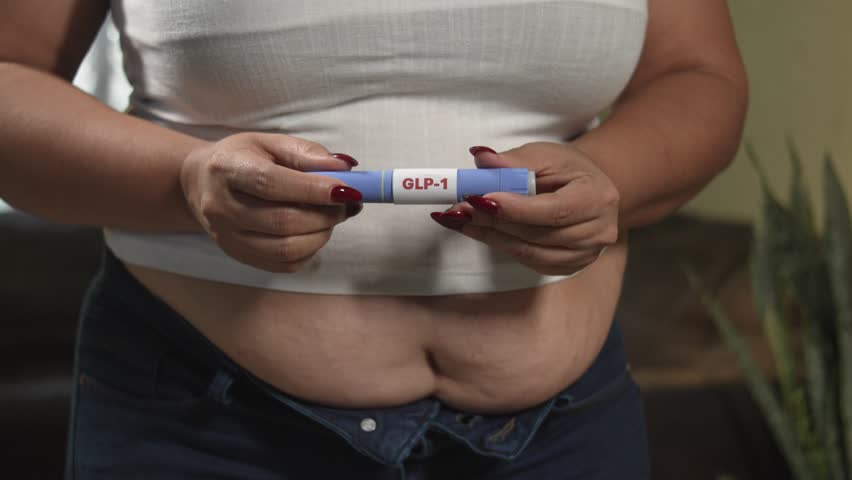 Overweight patient setting up GLP-1 medication pen at home, modern diabetes, weight management