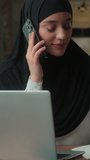 Joyful smiling talking mobile phone muslim islam business woman in hijab female girl arabian multitasking businesswoman executive looking laptop writing working in office agency discuss project order - Powered by Shutterstock - Get 15% off with code: PIKWIZARD15