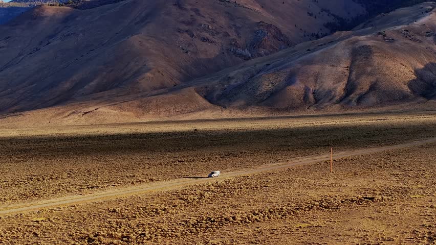 Golden valley floor with Borah Peak rising in background along Highway 93 Idaho