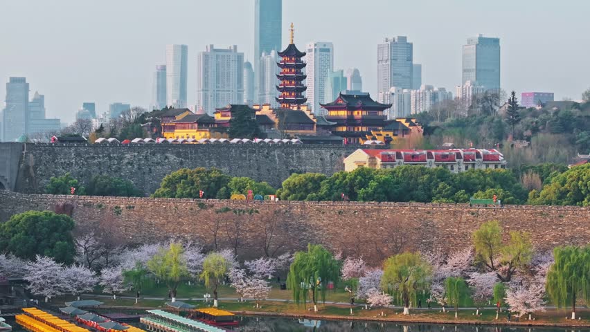 Ancient Jiming Temple and city wall with cherry blossoms in Nanjing, China