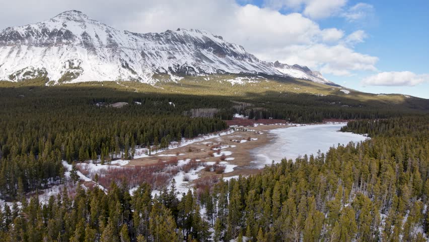 Aerial view of Glacier National Park Mountain Range and meadow in winter, Montana
