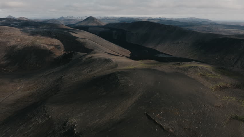 Aerial drone view of the Geldingadalir volcanic area in Iceland, featuring rugged terrain, cooled lava fields and dramatic Nordic landscape. Remote natural environment and geology concept.