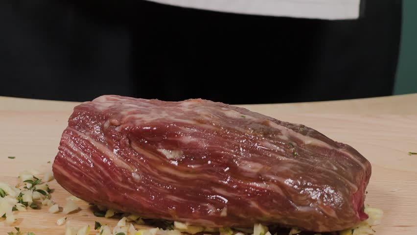 The chef pours oil onto a dish