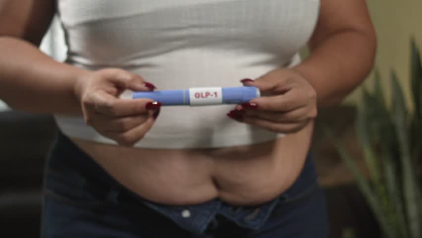 Female hands preparing semaglutide GLP-1 pen for self-injection, metabolic health and weight loss therapy