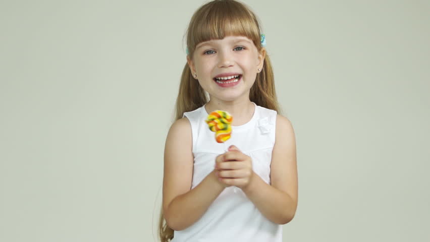 Girl with a lollipop laughing
