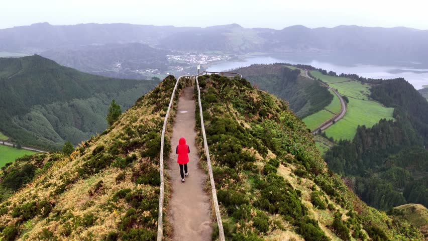 female hiker walking to the Boca do Inferno viewpoint in Sete Cidades natural park in Sao Miguel, the Azores, tourism and hiking in Portugal Atlantic islands