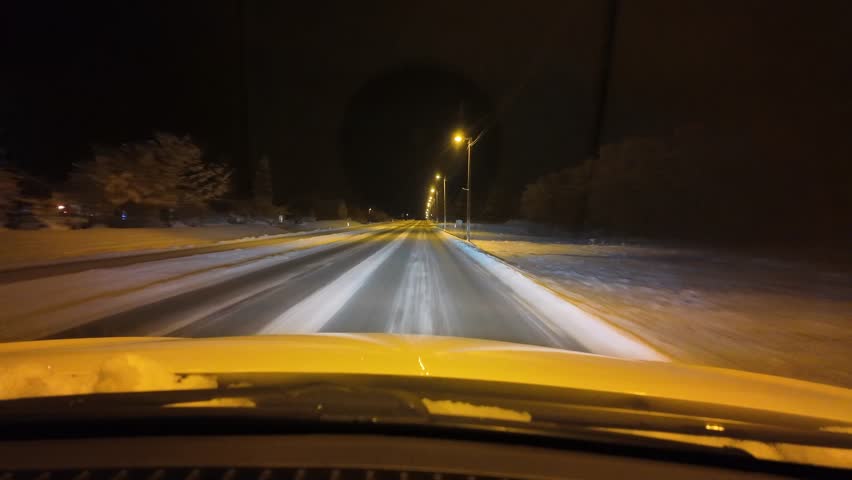 Kristiansund, Moere og Romsdal, Norway - November 19th 2025: Dashboard camera view from a car driving on a winter road at night.