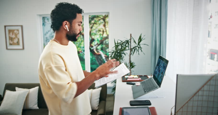 Man, laptop and video call with documents in home for finance planning, client query and remote work. Freelance financial advisor, tech and webinar with earphones for report feedback, advice and help