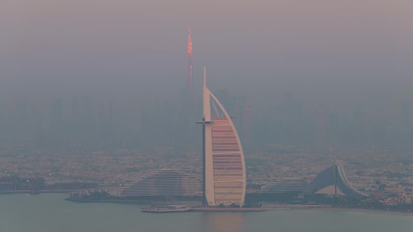 Dubai iconic skyline with Burj Khalifa lit by setting sun, United Arab Emirates