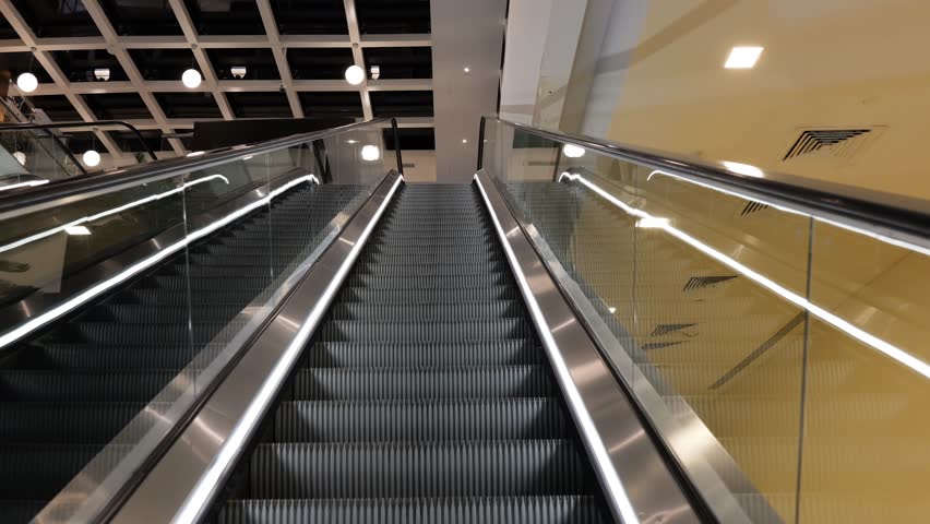 Glistening Escalator Ascending Through Modern Atrium Space