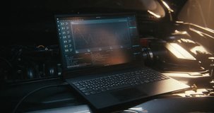 Laptop Screen, Positioned Right Next Car Engine, Displays Real Time Telemetry, Graphs, Lines System Code. Interface Shows Engine Performance Metrics, Fault Code Scanning, Digital System Monitoring. - Powered by Shutterstock - Get 15% off with code: PIKWIZARD15