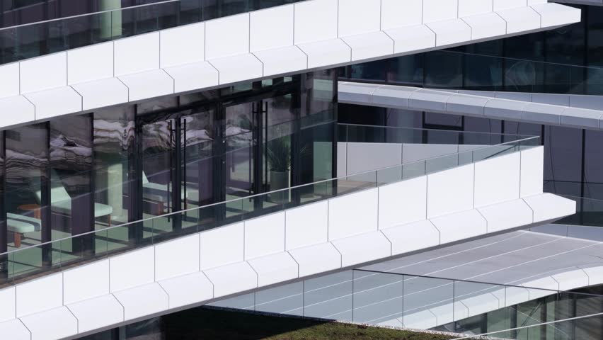 Aerial drone view of a modern office building with angular architecture, rooftop terrace, wooden deck flooring, and green roof elements in Vilnius, Lithuania.
