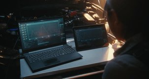 Woman Uses Dual Screen Setup, Featuring Laptop and Tablet, to Monitor Complex Engine Performance Graphs and Sensor Logs Simultaneously. Software Driven Car Maintenance, Advanced Technical Expertise. - Powered by Shutterstock - Get 15% off with code: PIKWIZARD15