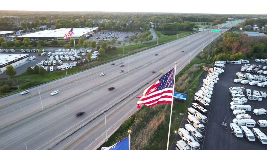 Aerial shot of American Flag and State of Wisconsin Flag in Green Bay Wisconsin at sunset.