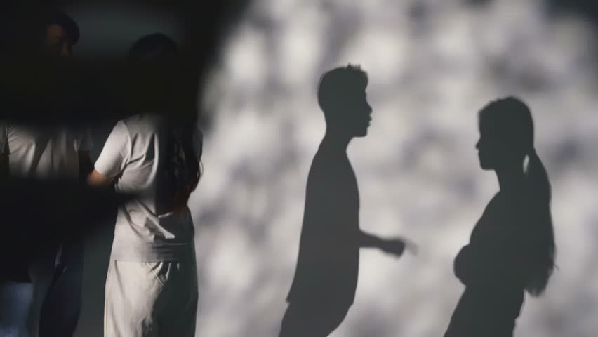 Silhouette of unhappy couples battle, having an argue, blaming, insulting. Stressful depressed young woman from domestic violence abused, depressive state, the victim of violence from her husband