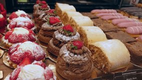 Variety of gourmet French pastries and cakes displayed in luxury bakery window with slow panning motion - Powered by Shutterstock - Get 15% off with code: PIKWIZARD15