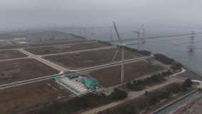 Aerial view of wind turbines and solar panels on a foggy day - Powered by Shutterstock - Get 15% off with code: PIKWIZARD15
