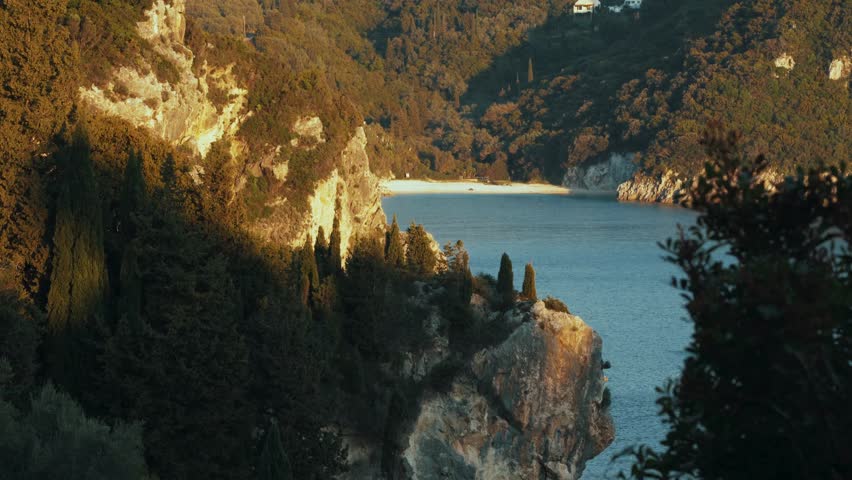 This video captures the breathtaking beauty of a serene lake nestled among lush green trees and majestic mountains during a stunning sunset. The tranquil atmosphere and picturesque landscape evoke feelings of peace and relaxation, inviting viewers to escape into nature