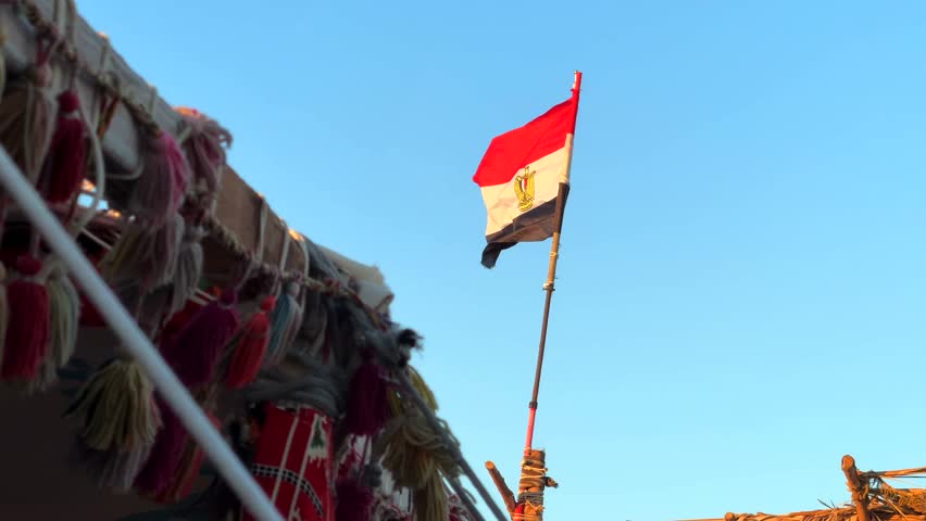 Egyptian Flag Waving on Top of Bedouin Desert Camp Tent at Sunset in Ras Muhammad National Park