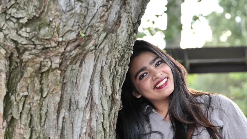 Bangladeshi young woman smiling in nature enjoying a moment of happiness