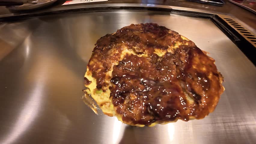 POV Cooking Japanese Okonomiyaki on Hot Griddle
