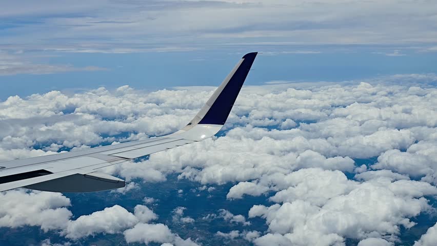 Aircraft Wing Over Cloudscape During Flight