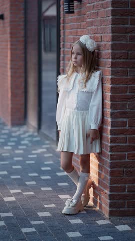 Little girl in elegant white dress. Concept of children's fashion.
