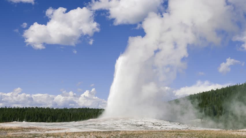 Old Faithful geyser erupts sending a tall column of steam and hot water into the sky in Yellowstone National Park geothermal landscape, Nature landscape, Travel tourism