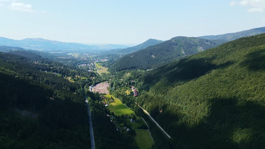 Serene Countryside With Mountains And Forests Visible. Aerial Shot Of Peaceful Valley With Hills And Rivers