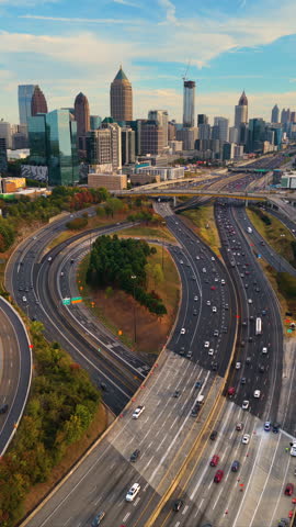 Futuristic aerial view of Atlanta city landscape with skyscrapers and layered road networks, overpasses and busy highway traffic forming a vital transportation artery.