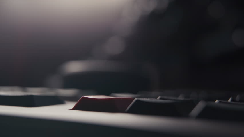 Person Pressing Red Key on Computer Keyboard for System Reset