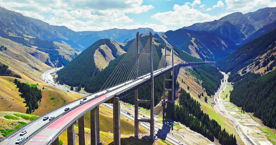 Aerial view of Guozigou cable-stayed bridge spanning a mountain valley in Xinjiang, China.