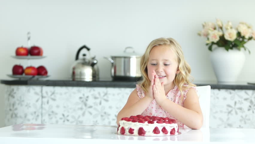 Girl moves closer strawberry cake
