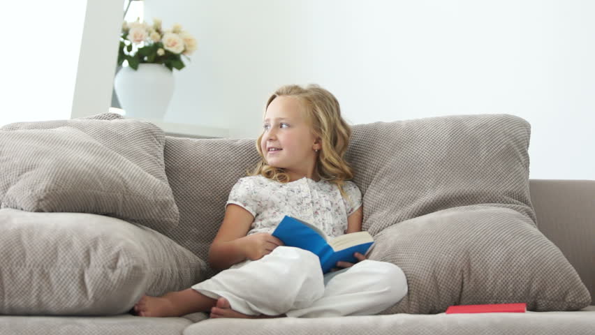 Girl sitting on the couch and read a good book
 | Shutterstock HD Video #4022302