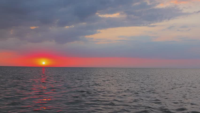 Orange sunset in the evening on the horizon over the lake