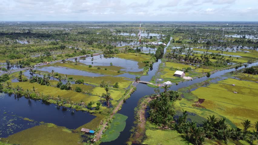 Aerial view of vast agricultural land being flooded