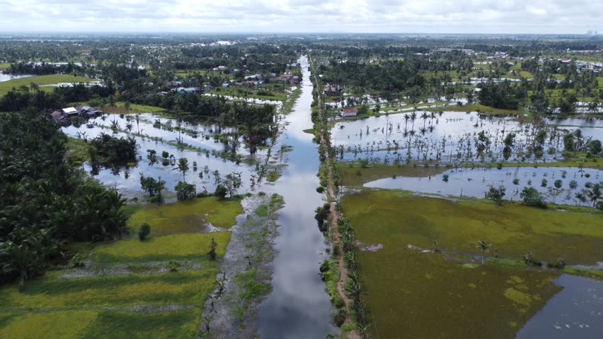 Aerial view of vast agricultural land being flooded