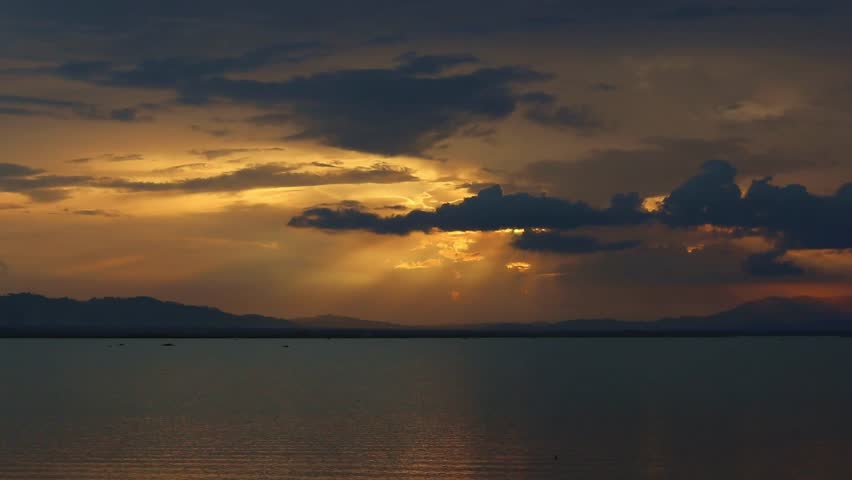 Dramatic Sunset Over Lake with Mountain Silhouette