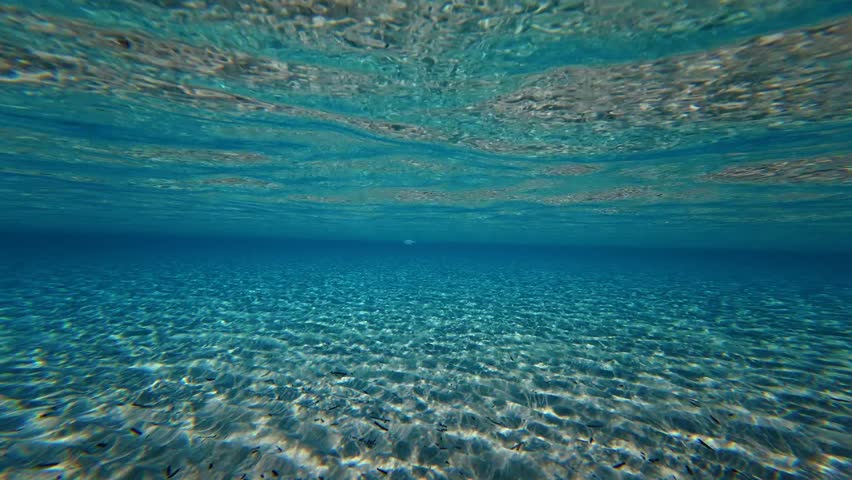 Underwater slow motion video of paradise Caribbean sandy sea bed with turquoise crystal clear sea and sunlight reflections
