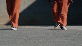 Low angle view of female inmates' feet walking in an orange jumpsuit in the prison yard - Powered by Shutterstock - Get 15% off with code: PIKWIZARD15